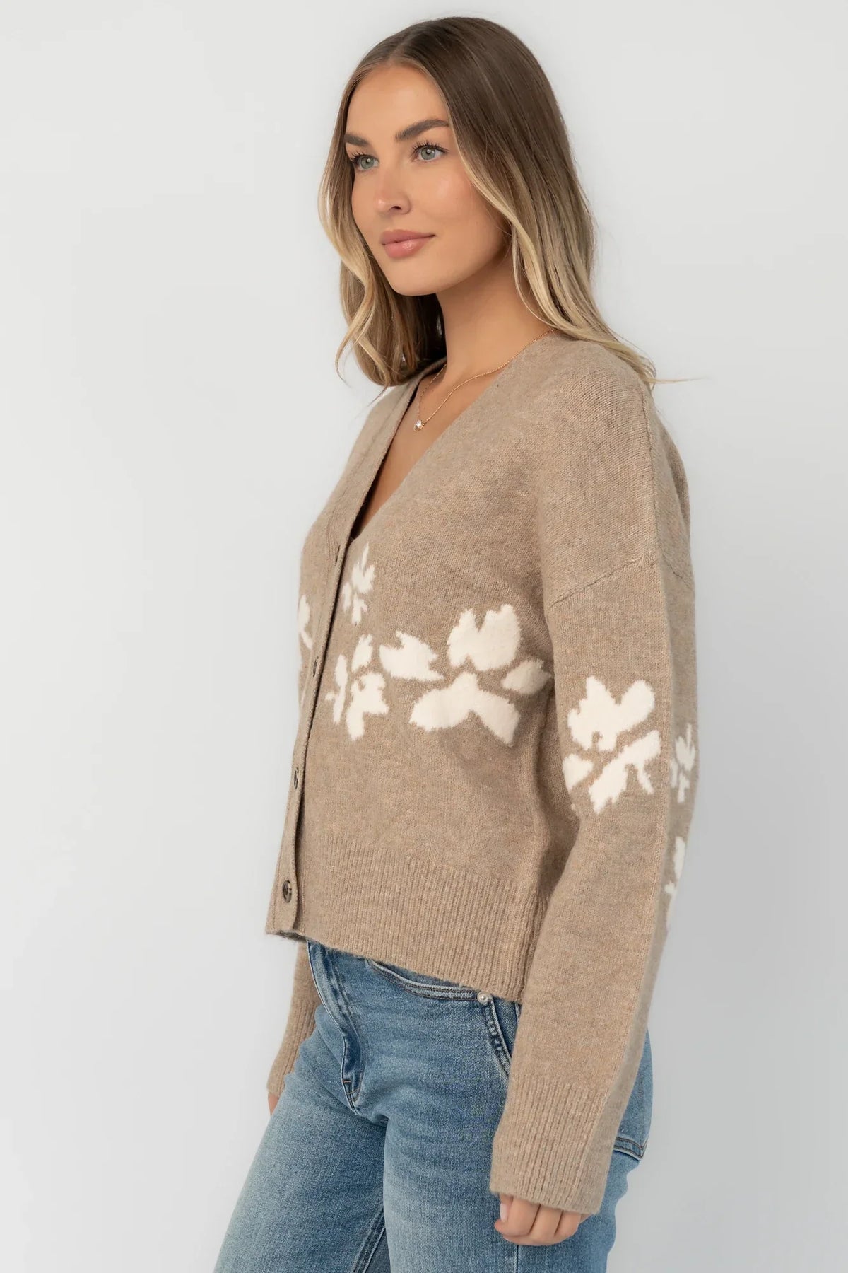 Taupe floral knit cardigan with a V-neckline, button-front closure, long sleeves, ribbed trim, and a relaxed silhouette.