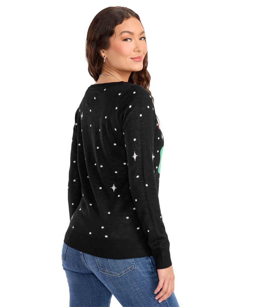 Woman wearing a black sweater with a festive design of Santa riding a unicorn on a white background