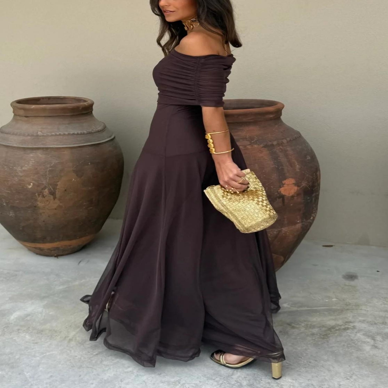 Stylish brown off-shoulder maxi dress for women, a perfect elegant wedding guest or evening party outfit.