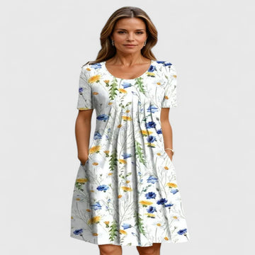 Elegant women's floral summer midi dress with short sleeves and practical pockets, perfect for casual or party wear.