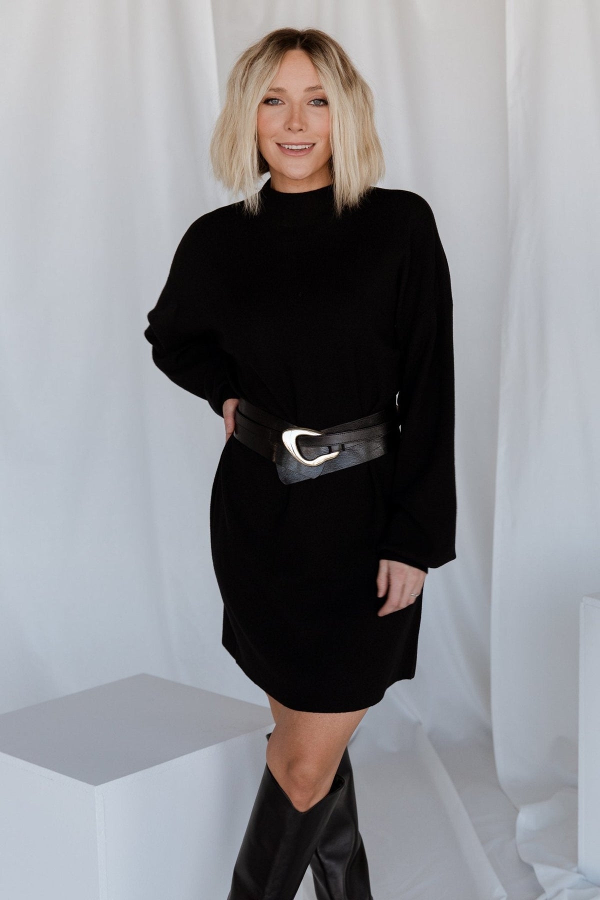 Close-up of sweater dress sleeve and shoulder detailing, showing long bubble sleeve silhouette and knit texture for added visual interest.