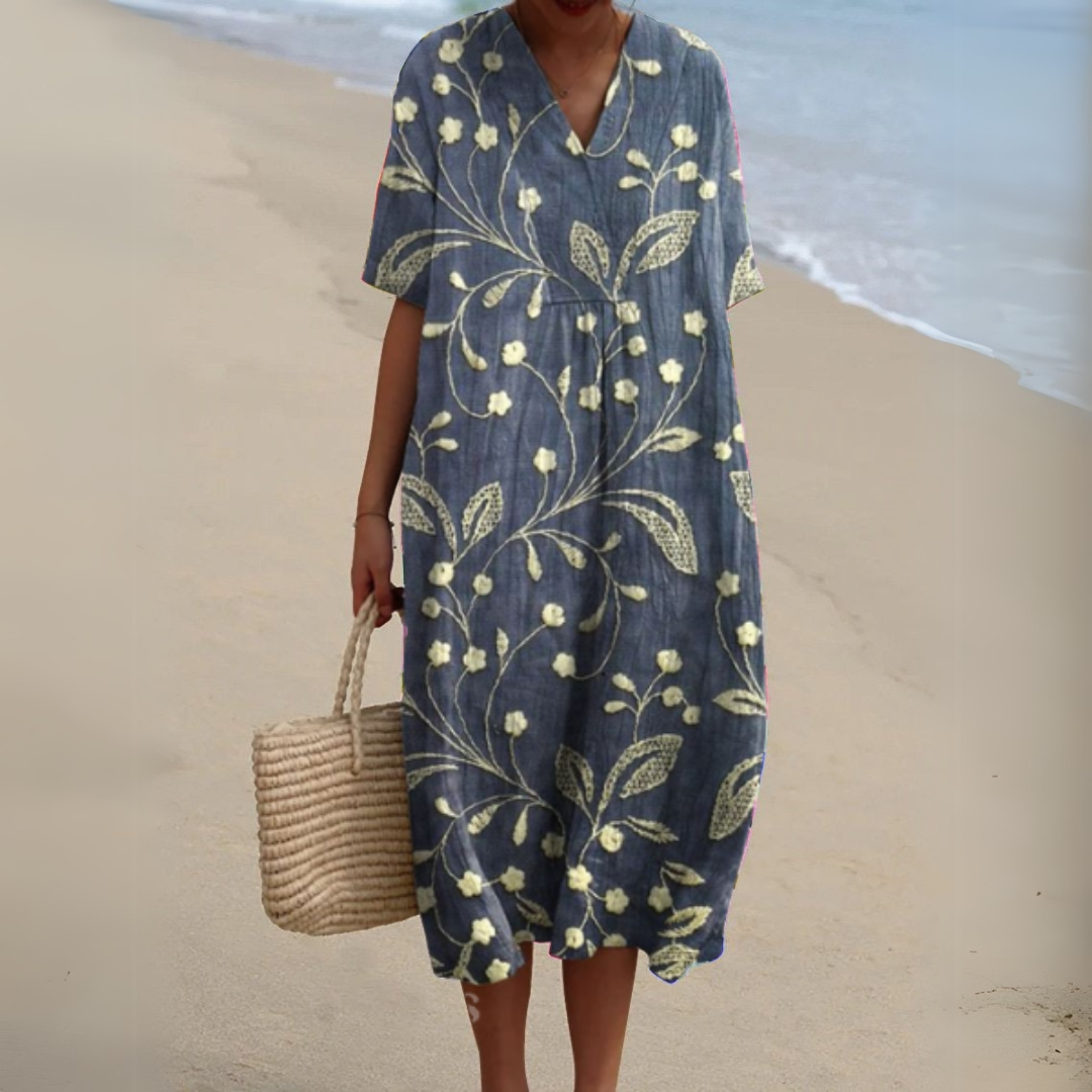 Woman confidently wearing a stylish multicolour V-neck floral dress for summer.