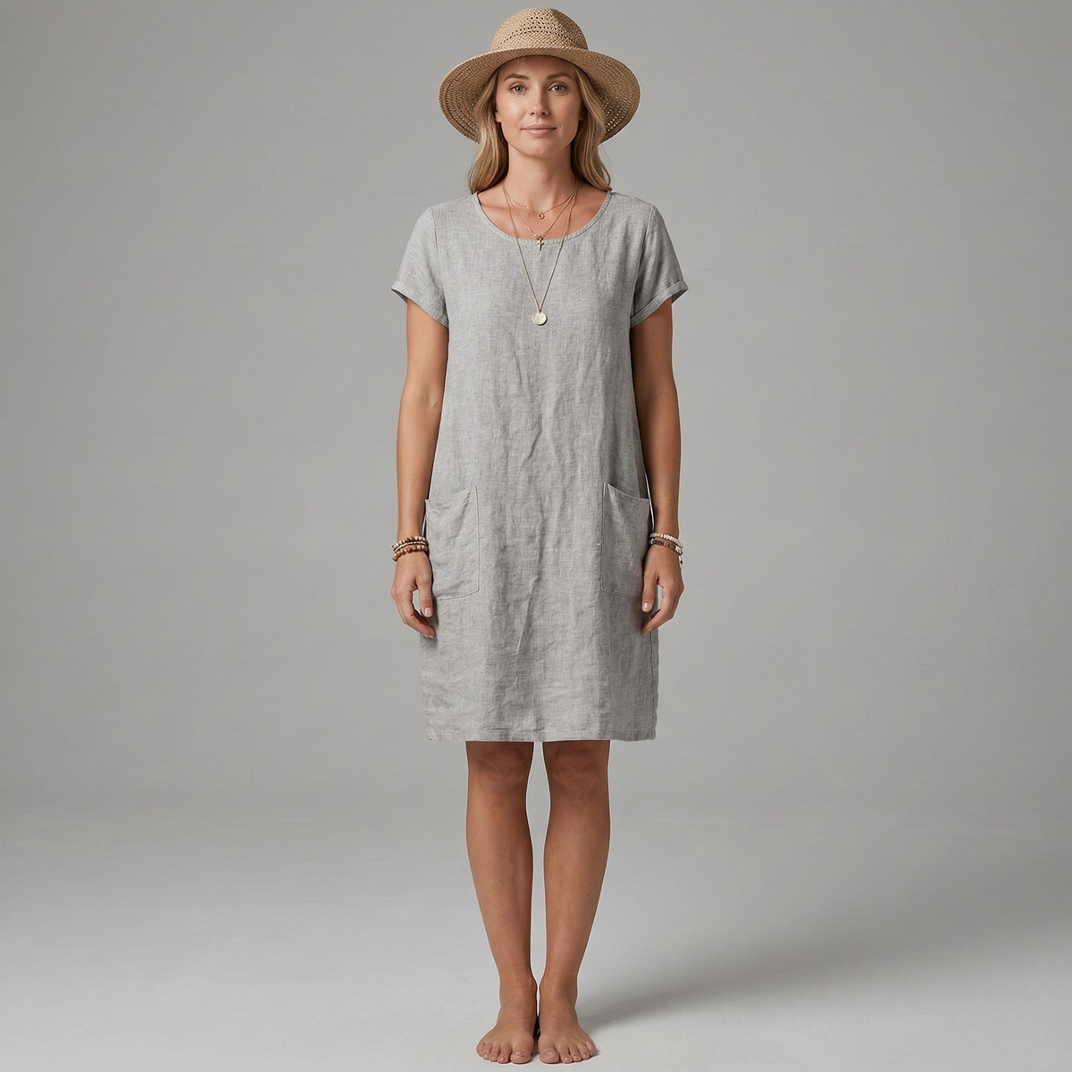 Comfortable women's short sleeve mini dress, perfect for summer. Features useful front pockets and a relaxed casual fit.
