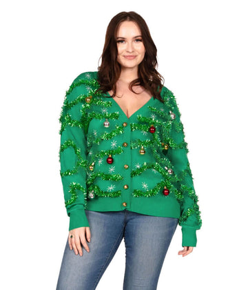 Woman wearing a green Christmas tree-themed sweater on a white background