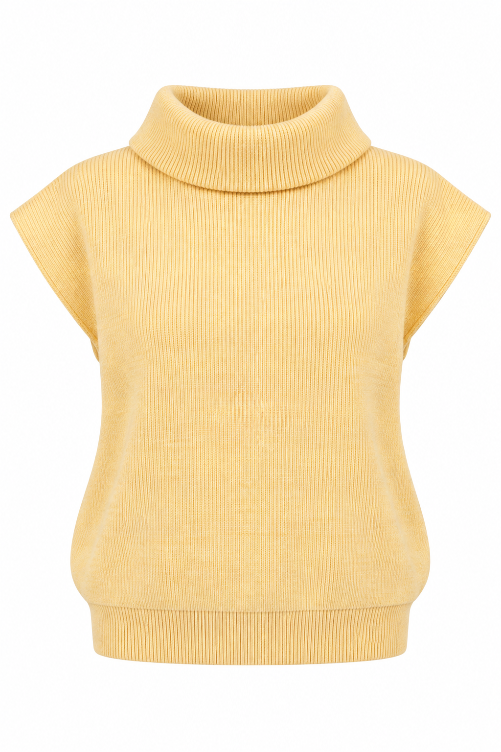 A woman wearing a pale yellow ribbed knit mock neck top with cap sleeves and light blue jeans, standing against a white brick wall.